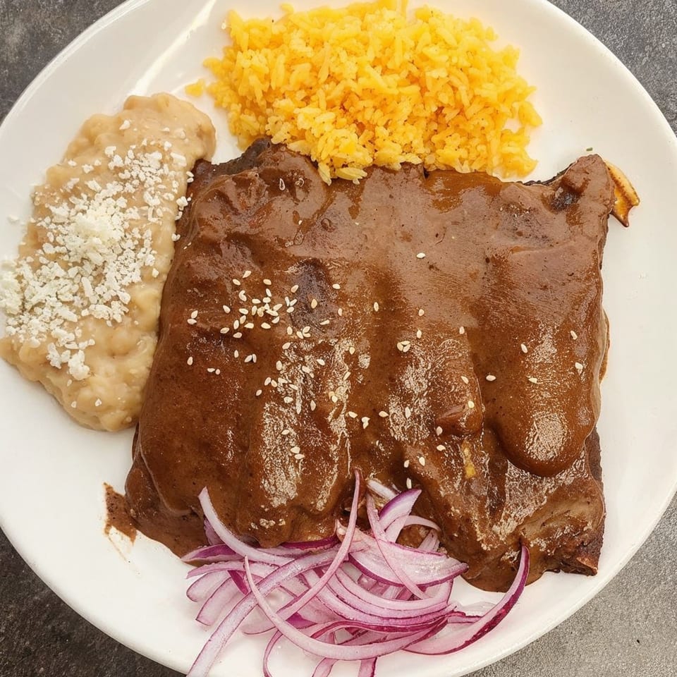 La Perla Tapatia Goshen's mole ribs with yellow rice, refried beans, and red onion.