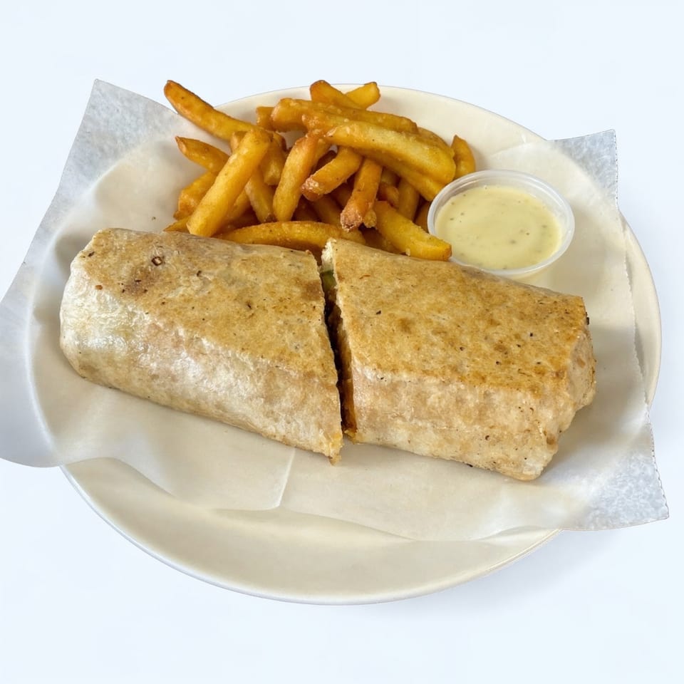 A La Perla Tapatia Goshen burrito, cut in half, with a side of golden fries and dipping sauce.